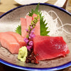 fresh sashimi slices in a plate with wasabi and Japanese herbs