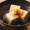 cold tofu with soy sauce and chopped leak on top Japanese style