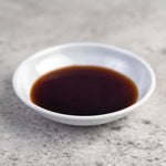 soy sauce in a small white plate